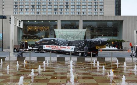 Arrival of the Mayor's Christmas Tree with shops in the background